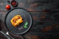 Italian Lasagne with tomato bolognese sauce and mince beef meat, on plate, on old dark  wooden table background, top view, flat Royalty Free Stock Photo