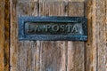 Italian letterbox with the text La Posta, letters in Italian