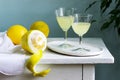 Italian liqueur limoncello in crystal glasses and ripe lemons on a wooden table. Royalty Free Stock Photo