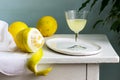 Italian liqueur limoncello in crystal glasses and ripe lemons on a wooden table. Royalty Free Stock Photo