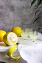 Italian liqueur limoncello in crystal glasses and ripe lemons on a wooden table Royalty Free Stock Photo