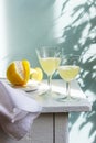 Italian liqueur limoncello in crystal glasses and ripe lemons on a wooden table Royalty Free Stock Photo