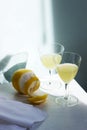 Italian liqueur limoncello in crystal glasses and ripe lemons on a wooden table Royalty Free Stock Photo