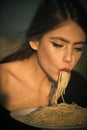 Italian macaroni or spaghetti for dinner, cook. Woman eating pasta as taster or restaurant critic. Chef woman with red