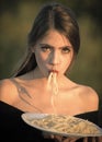 Italian macaroni or spaghetti for dinner, cook. Woman eating pasta as taster or restaurant critic. Hunger, appetite