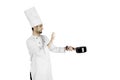 Italian male chef holding a pan on studio