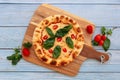 Italian Margerita pizza with fresh tomato and mozzarella cheese isolated on wooden background top view fast food Royalty Free Stock Photo