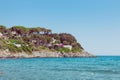 Italian maritime coast of the Island of Elba with rocky ridge and perched house. Sea in Italy in the city of Procchio Royalty Free Stock Photo