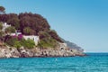 Italian maritime coast of the Island of Elba with rocky ridge and perched house. Sea, trees and rocks in Italy in the city of