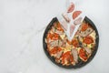 Close up of Meat black dough Pizza with ingredients on white marble background Royalty Free Stock Photo