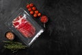 Italian meat cold cuts pack, on black dark stone table background, top view flat lay, with copy space for text Royalty Free Stock Photo