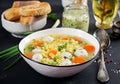 Italian meatball soup and Stelline gluten free pasta in bowl on black table. Royalty Free Stock Photo