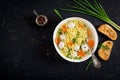 Italian meatball soup and Stelline pasta in bowl on black table. Royalty Free Stock Photo