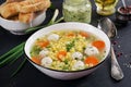 Italian meatball soup and Stelline gluten free pasta in bowl on black table. Royalty Free Stock Photo