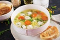 Italian meatball soup and Stelline pasta in bowl on black table. Royalty Free Stock Photo