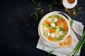 Italian meatball soup and Stelline pasta in bowl on black table. Royalty Free Stock Photo