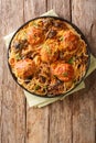Italian meatballs with a side dish of spaghetti with mushrooms and cheddar cheese close-up in a plate. Vertical top view Royalty Free Stock Photo