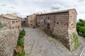 Italian medieval village details, historical stone square, ancient church abbey, old city stone buildings architecture. Radicofani Royalty Free Stock Photo