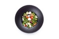 Italian mozzarella cheese and tomato salad with tomatoes and crisp crunchy fried bread cretins, view from above on a black plate Royalty Free Stock Photo