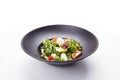 Italian mozzarella cheese and tomato salad with tomatoes and crisp crunchy fried bread cretins, view from above on a black plate Royalty Free Stock Photo