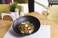 Italian mozzarella cheese and tomato salad with tomatoes and crisp crunchy fried bread cretins, view from above on a black plate Royalty Free Stock Photo