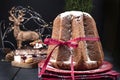 Italian Pandoro Christmas Cake with Lemon Cream. Decor and sweets for Christmas. A bokeh from the garlands and a black background