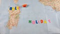 Italian paper travel geographical map with spinning toy car and the inscription holiday Royalty Free Stock Photo