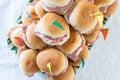 Italian party panini piled in stack in finger food style. Small panini sandwich with ham and salami. Italian food birthday party