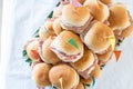 Italian party panini piled in stack in finger food style. Small panini sandwich with ham and salami. Italian food birthday party