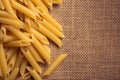 Italian pasta close up and sackcloth background Royalty Free Stock Photo
