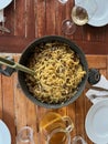 Italian pasta cooking spaghetti with mushrooms. White vino