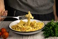 Italian pasta in a creamy sauce with shrimp on a plate sprinkled with spices lifts with a fork, top view. Royalty Free Stock Photo