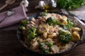 Savory pasta dish with tortellini, ham, parmesan cheese and broccoli Royalty Free Stock Photo