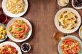 Italian pasta dishes forming a frame for copy space, overhead flat lay shot