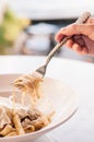 Italian Pasta fettuccine alfredo with chicken, parmesan and truffle. Side view with fork.