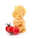 Italian pasta fettuccine nest and cherry tomato Royalty Free Stock Photo