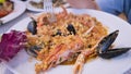 Italian pasta. Fregula with seafood. Traditional small round Sardinian pasta with shellfish, langoustine, mussels and