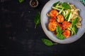 Italian pasta. Fusilli with meatballs, cucumber and basil on dark background. Royalty Free Stock Photo