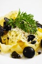 Italian pasta with grated cheese and black olives