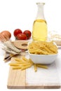 Italian pasta, macaroni quills with cherry tomatoes and olive oil in a glass bottle Royalty Free Stock Photo