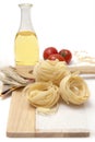 Italian pasta, macaroni tagliatelle with cherry tomatoes and olive oil in a glass bottle