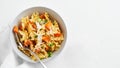 Italian pasta Mafalda Corta trafilata al bronzo with sauteed sweet potato, fennel, parmesan grated cheese on white background.