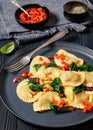 italian pasta mezzelune on a plate, top view