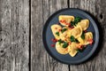 italian pasta mezzelune on a plate, top view