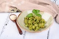 Italian pasta named Orecchiette with pesto of Genoa, sauce and parmesan cheese