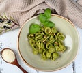 Italian pasta named Orecchiette with pesto of Genoa, sauce and parmesan cheese