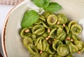 Italian pasta named Orecchiette with pesto of Genoa, sauce and parmesan cheese