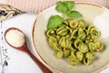 Italian pasta named Orecchiette with pesto of Genoa, sauce and parmesan cheese