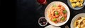 Italian pasta panorama with a place for text. Spaghetti with tomato sauce and basil, olives, wine, ravioli etc, overhead Royalty Free Stock Photo