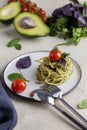 Italian pasta with pesto, herbs and cherry tomatoes at white plate Royalty Free Stock Photo
